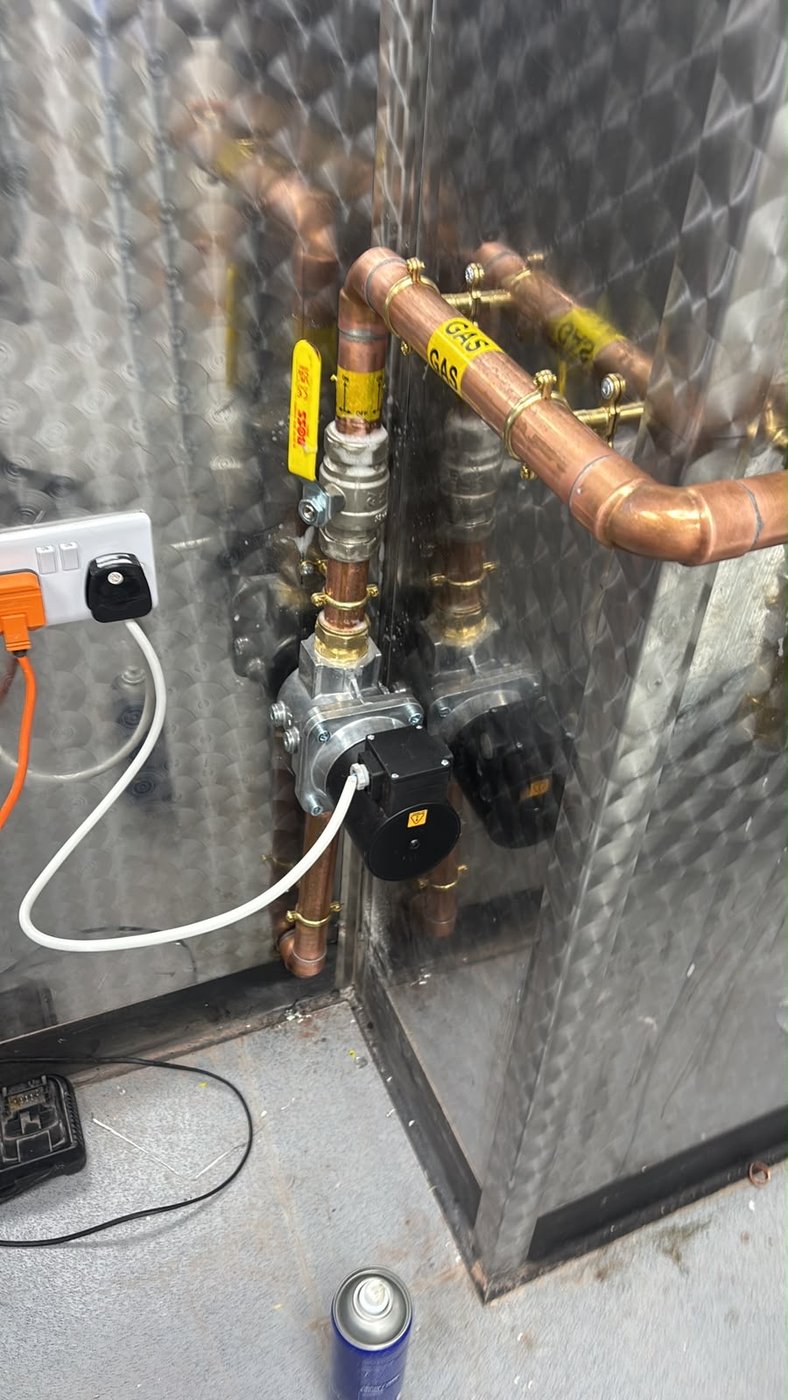 Engineer pressure testing a commercial gas supply with a manometer